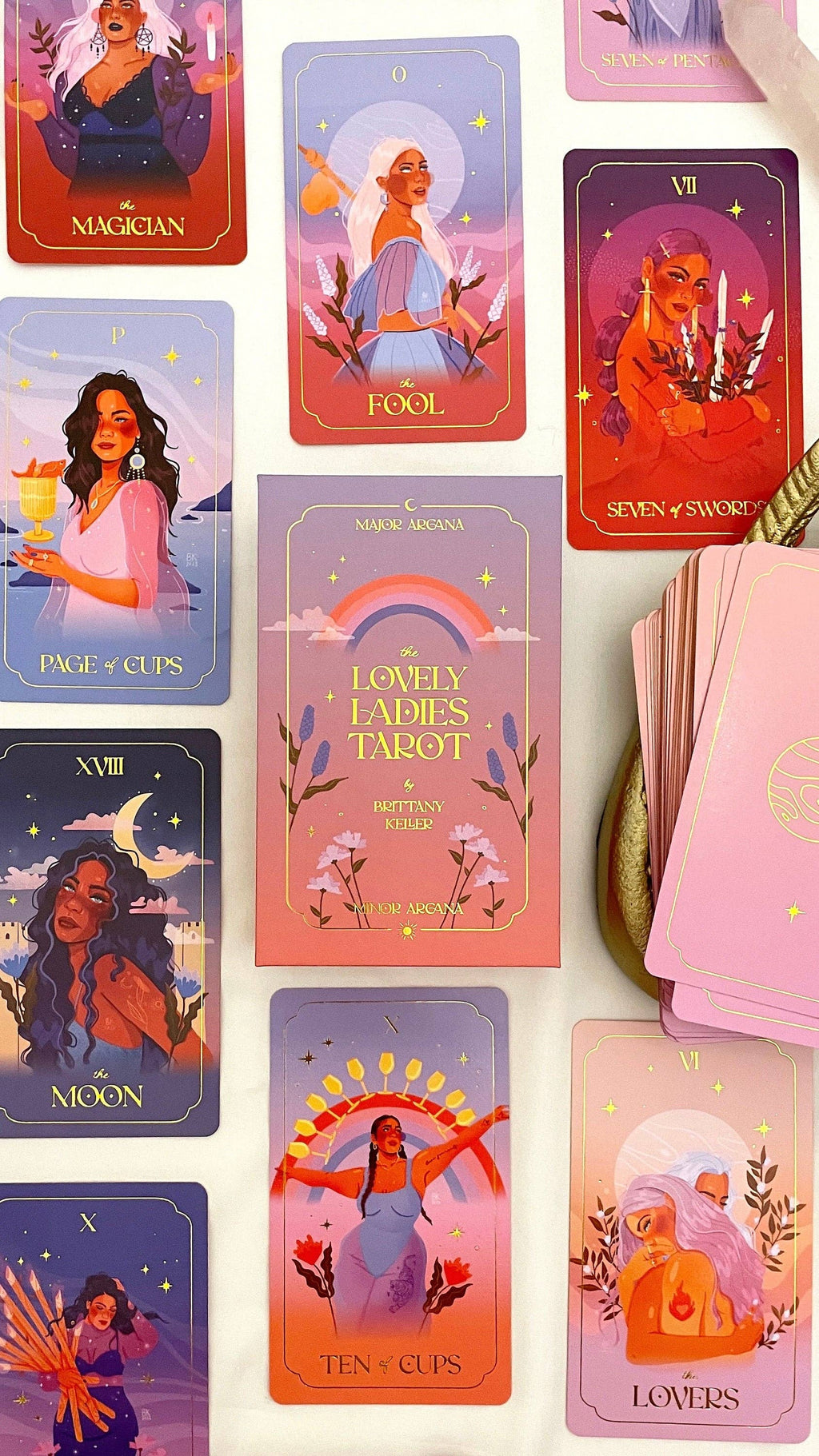 Collection of tarot cards with colorful designs and illustrations on a white background.