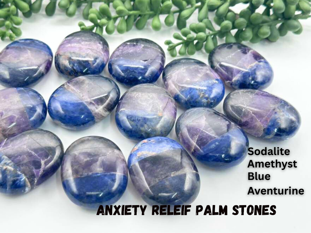 Anxiety relief palm stones with sodalite, amethyst, blue, and aventurine on a white background.