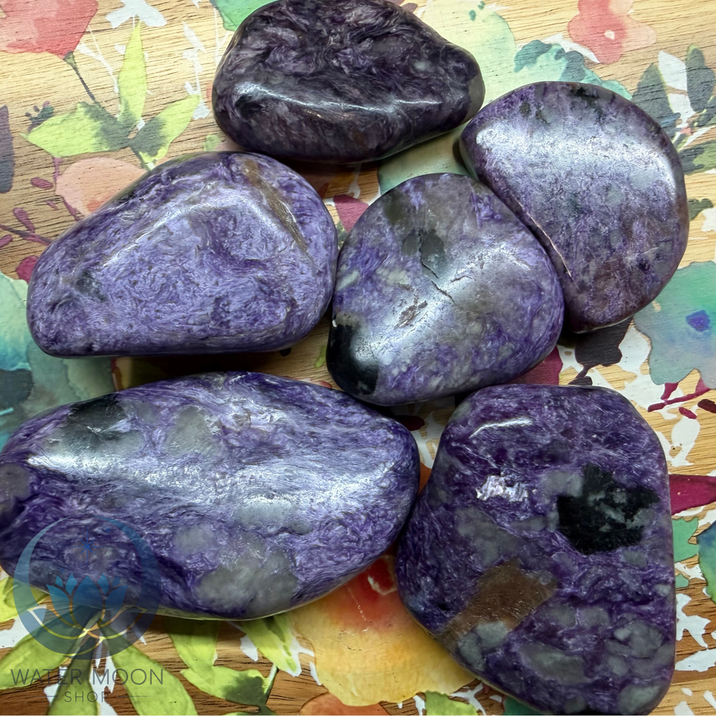 Purple stones on a colorful leaf-patterned surface