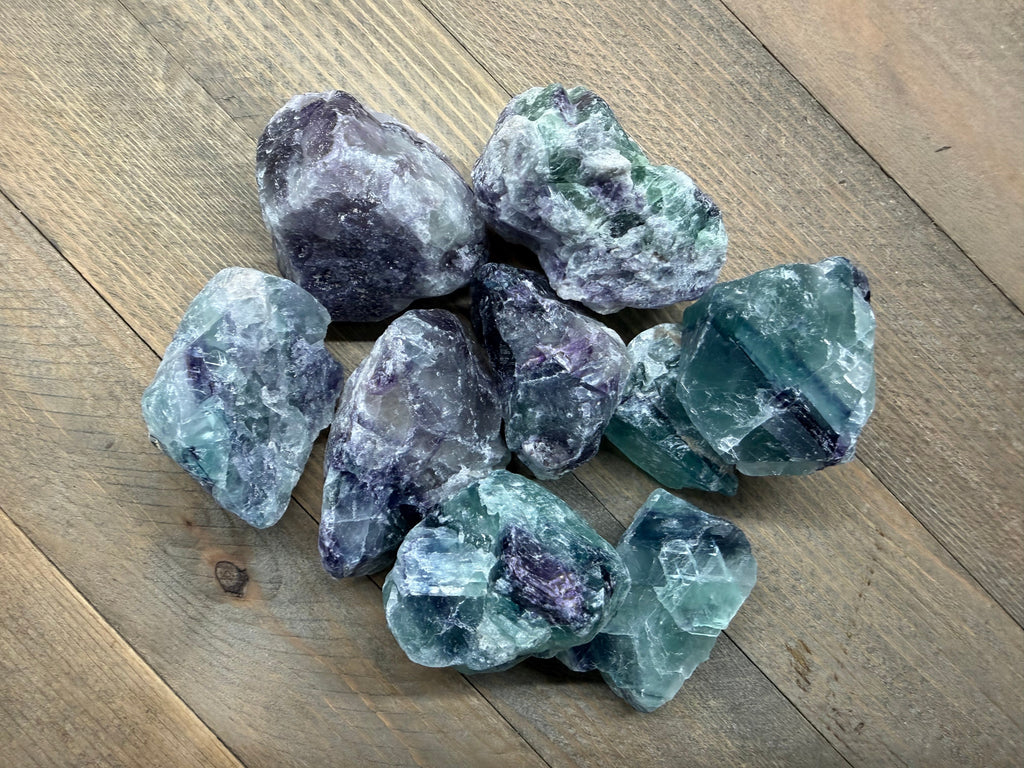 Collection of fluorite crystals on a wooden surface