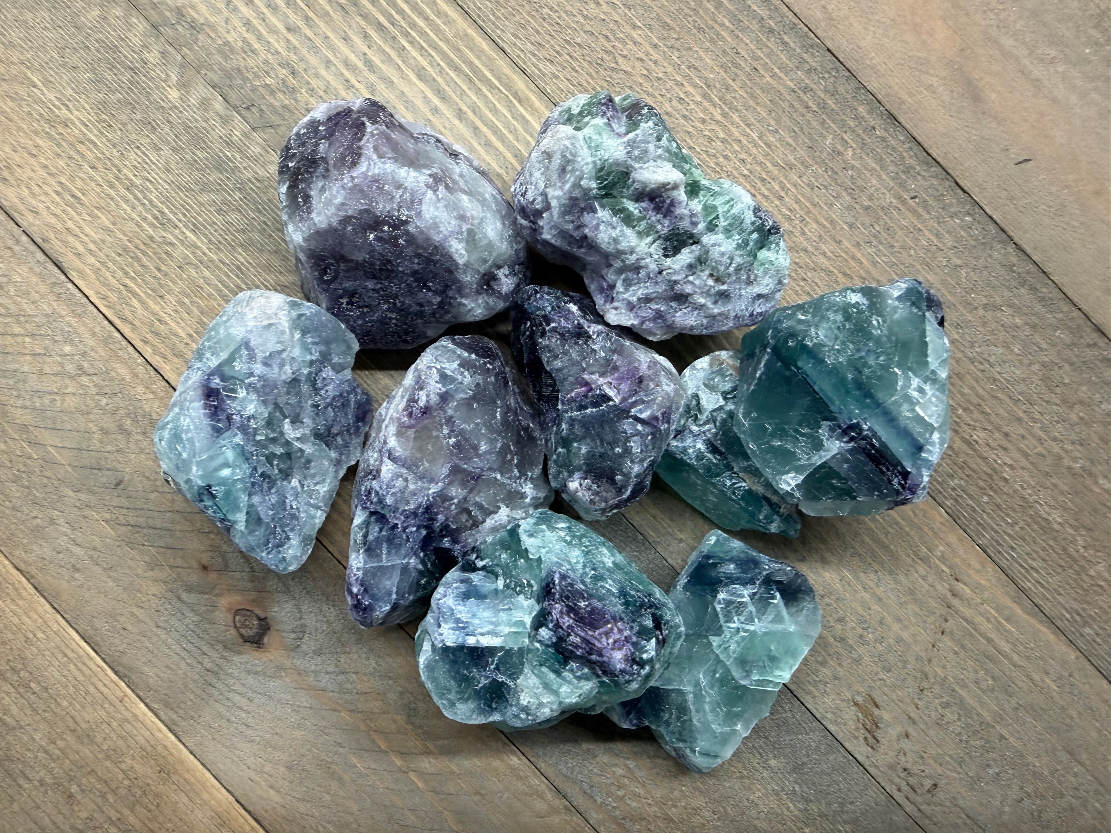 Collection of fluorite crystals on a wooden surface