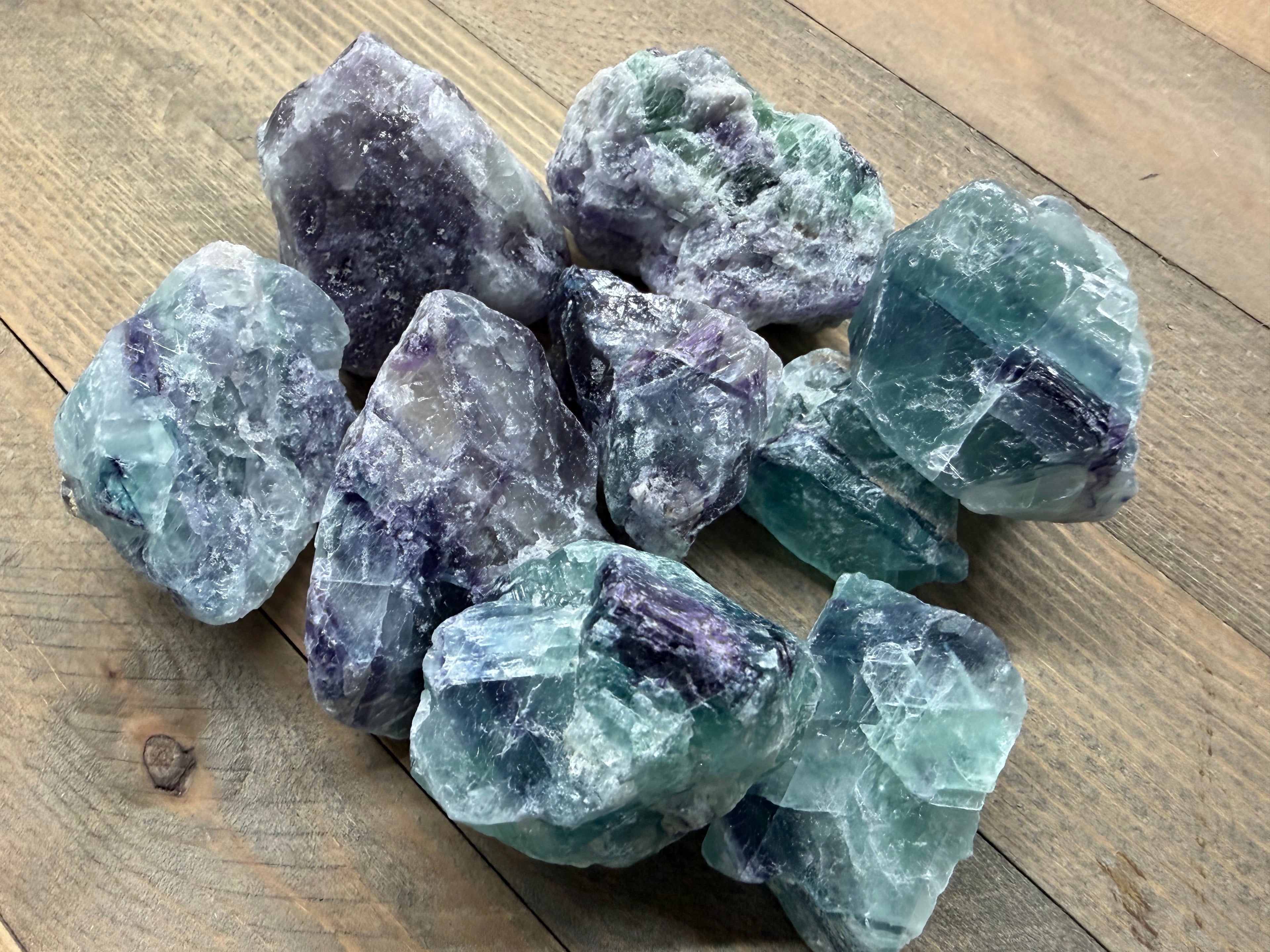 Collection of fluorite crystals on a wooden surface