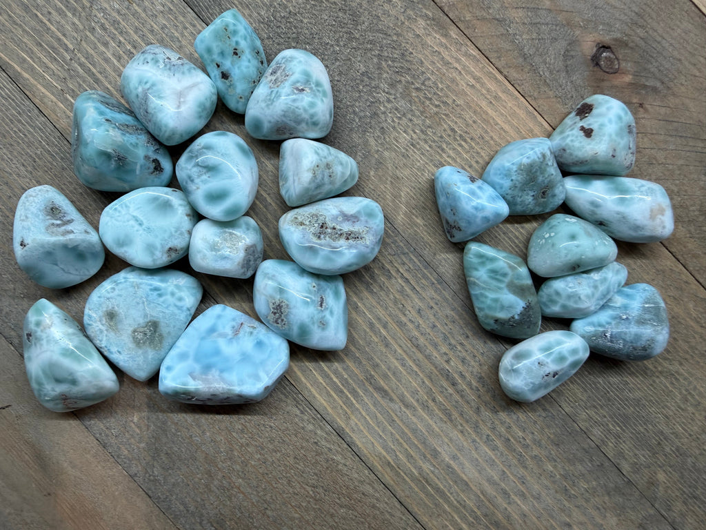 Collection of blue-green stones on a wooden surface