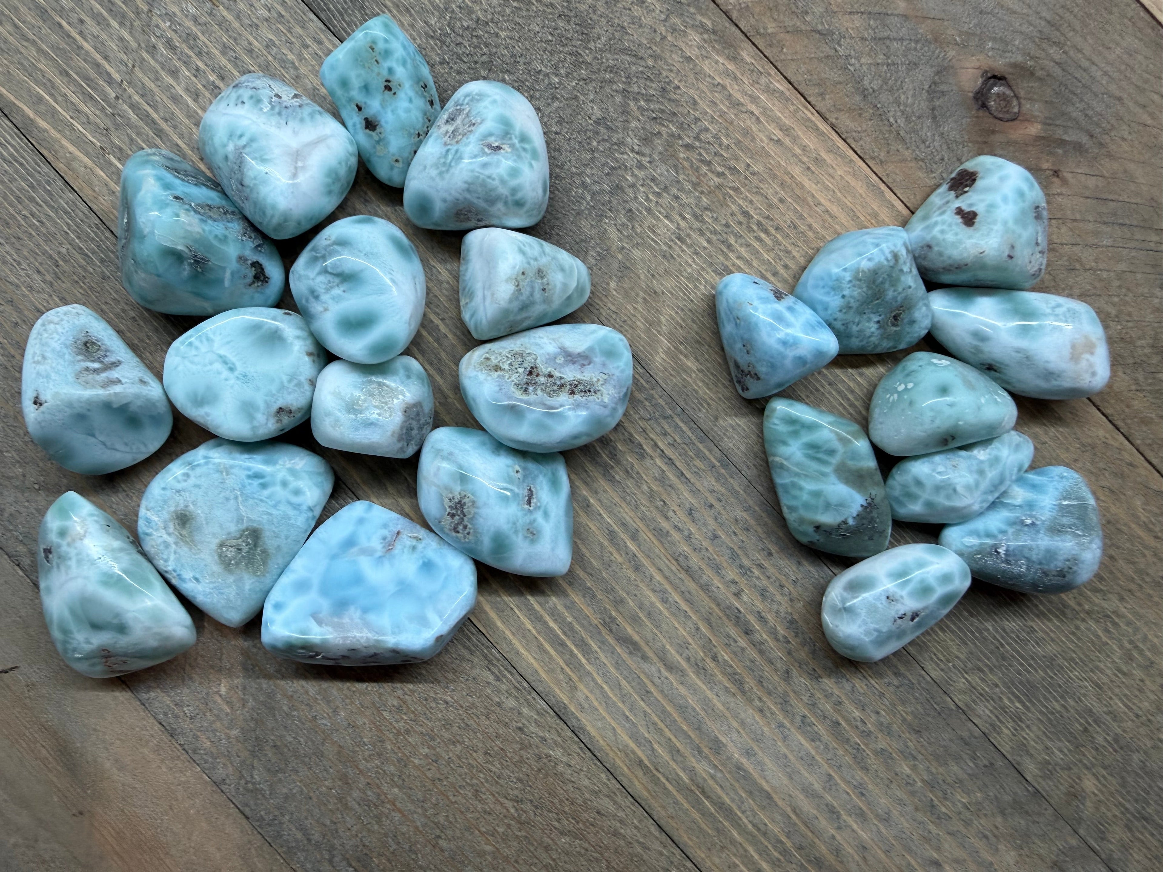 Collection of blue-green stones on a wooden surface