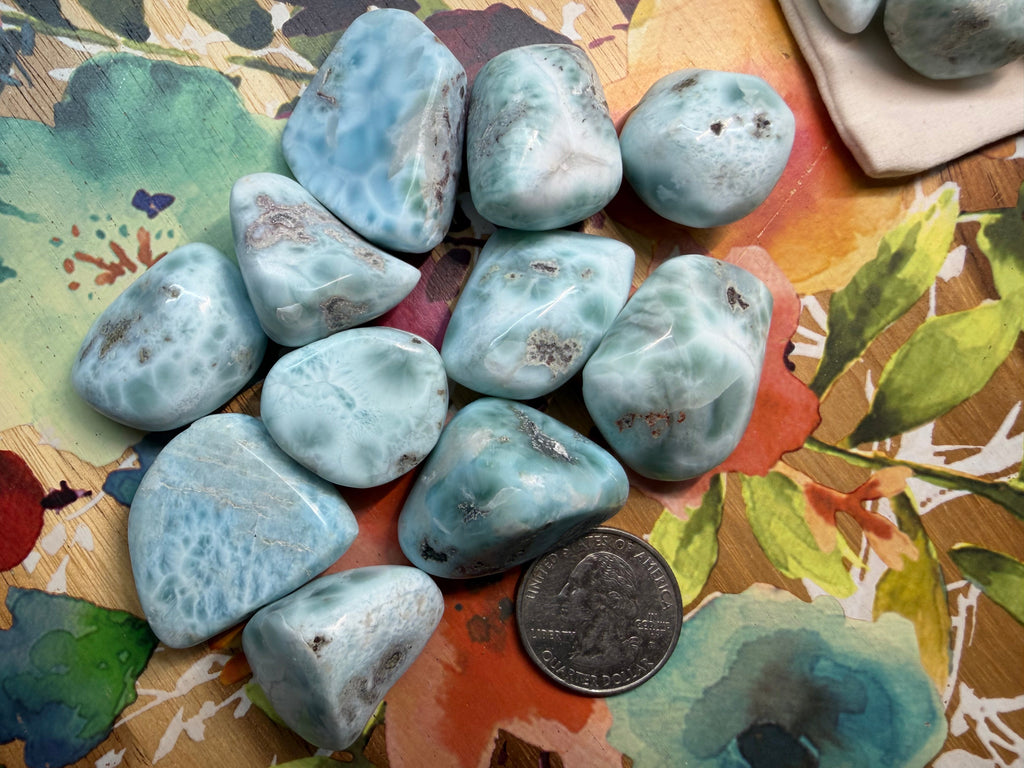 Collection of blue-green stones on a colorful fabric background