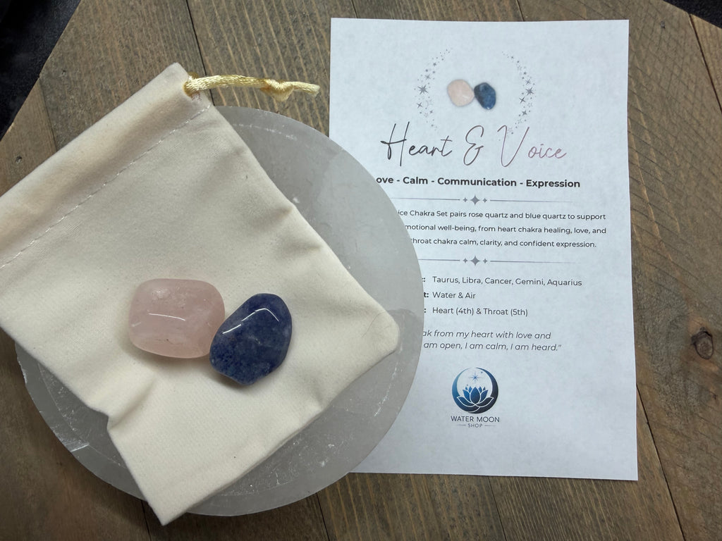 Two stones on a cloth pouch with a 'Heart & Voice' leaflet on a wooden surface