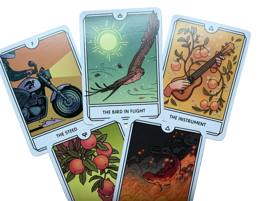 Five tarot cards with various illustrations on a wooden surface
