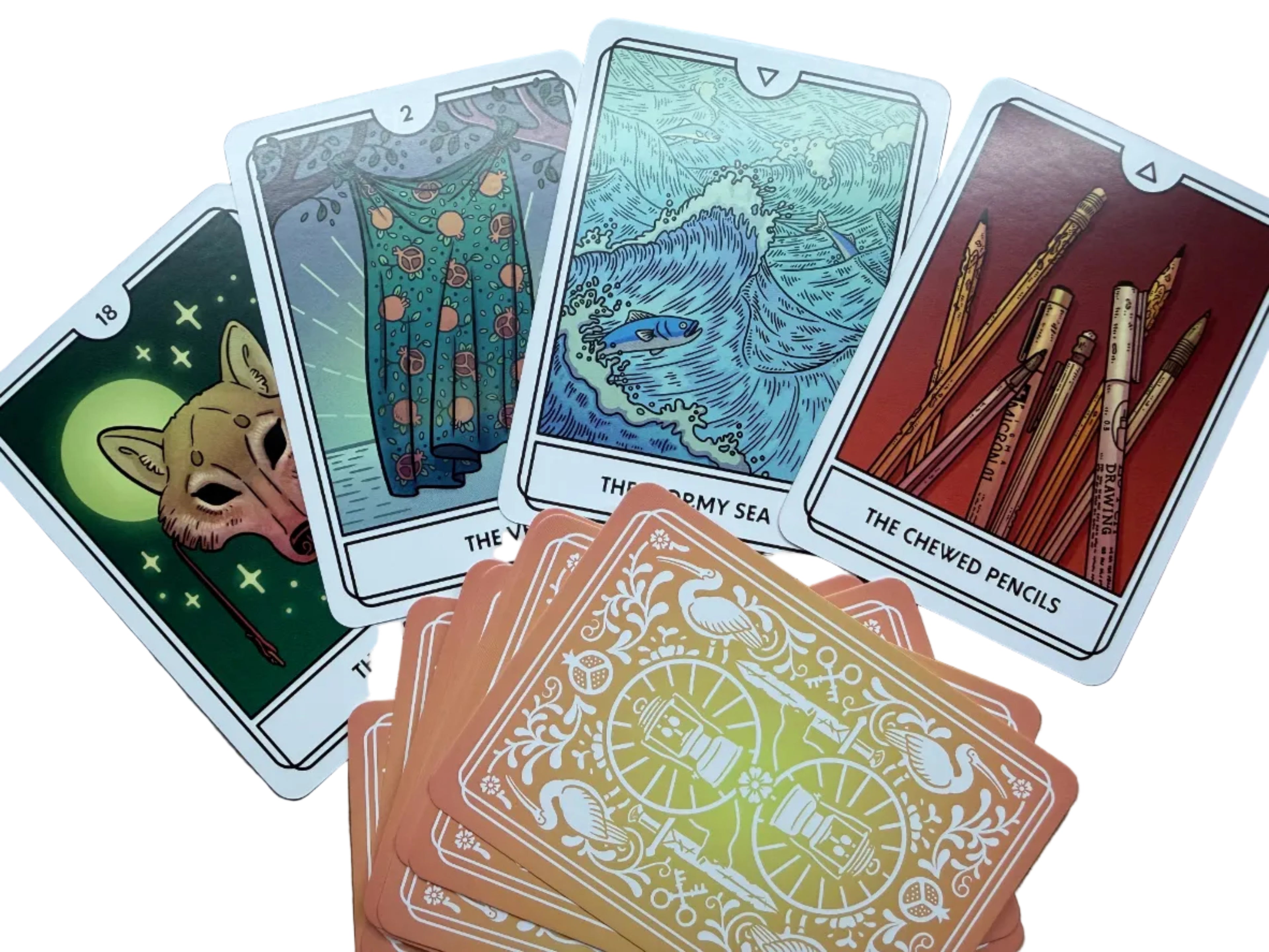 Set of tarot cards with various designs on a wooden surface