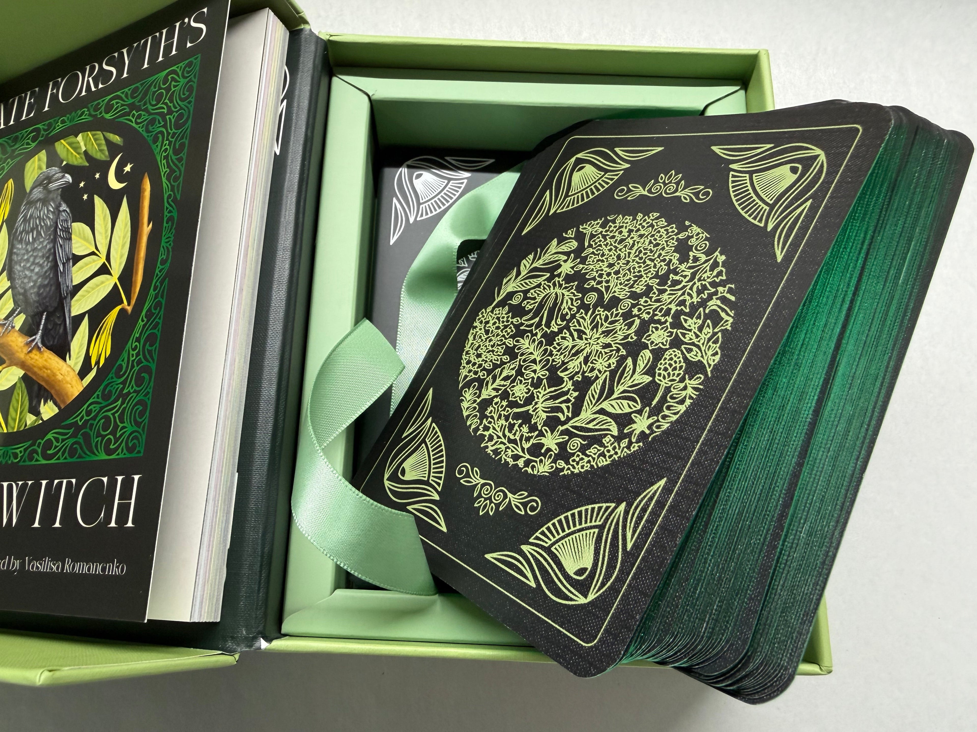 Green and black card deck with decorative cover in a box