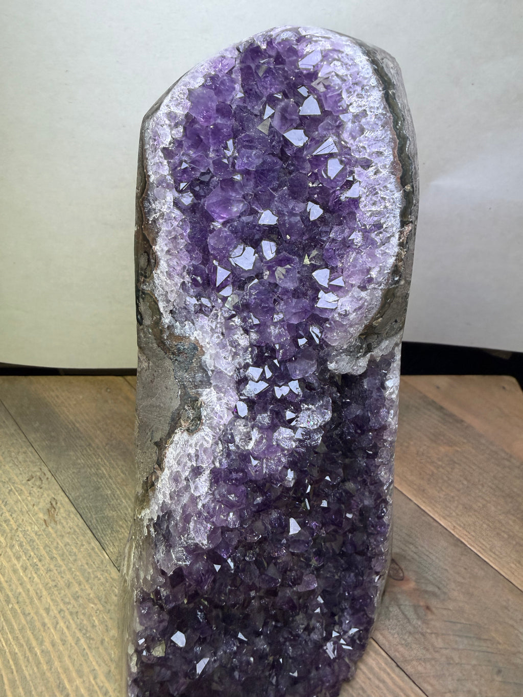 Amethyst crystal geode on a wooden surface