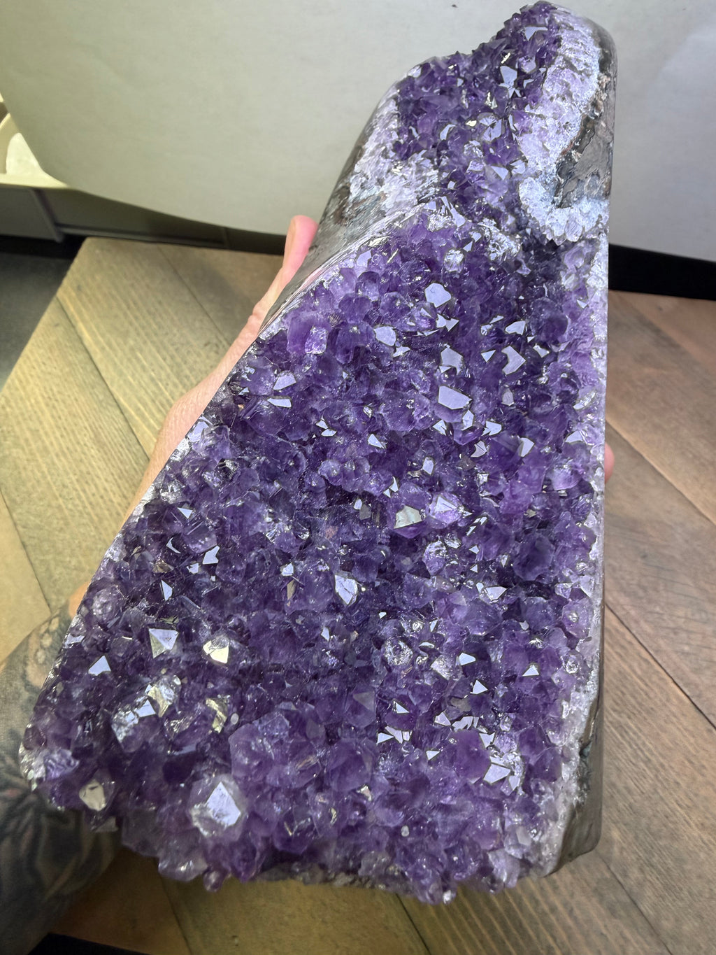 Amethyst crystal formation on a wooden surface