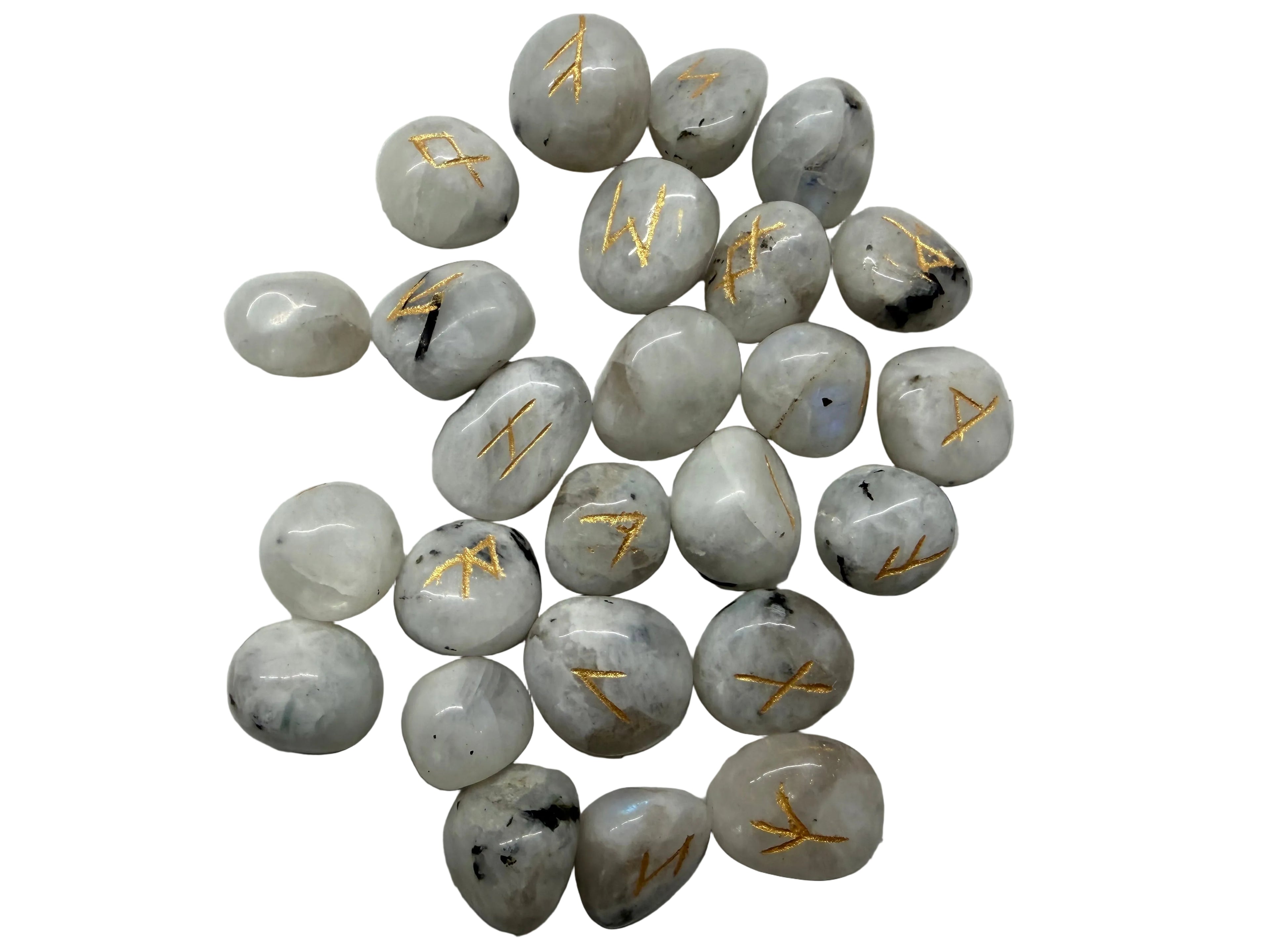 A pile of small polished white tumbled stones with engraved gold runic symbols, arranged on a light gray textured background.
