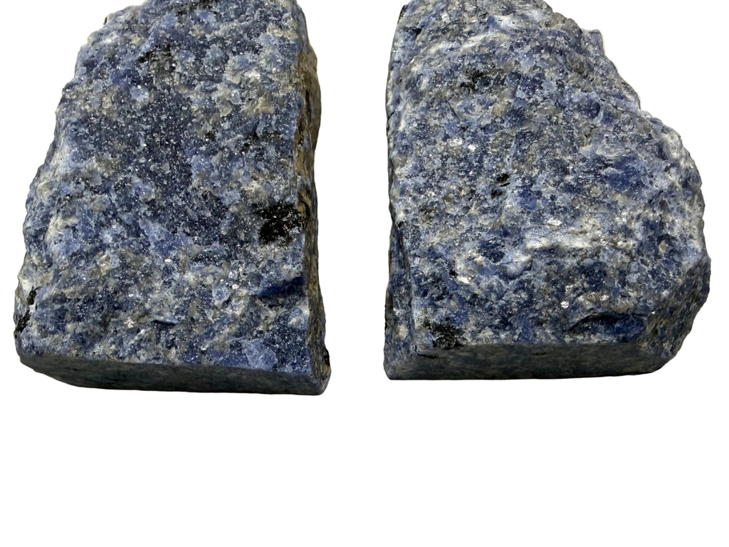Two rough sodalite crystal specimens with visible matrix, displayed side by side on a neutral light gray background.