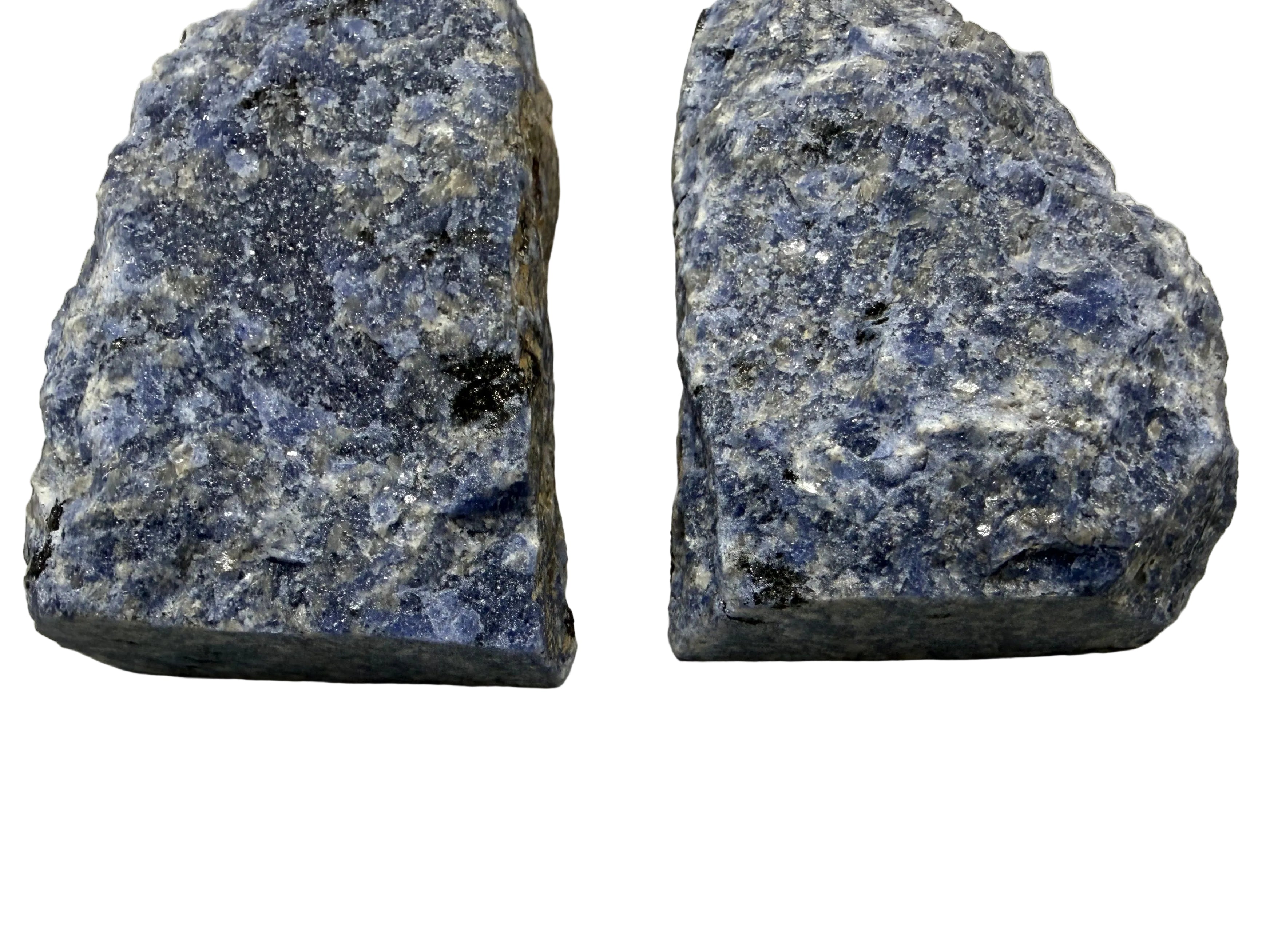 Two rough sodalite crystal specimens with visible matrix, displayed side by side on a neutral light gray background.