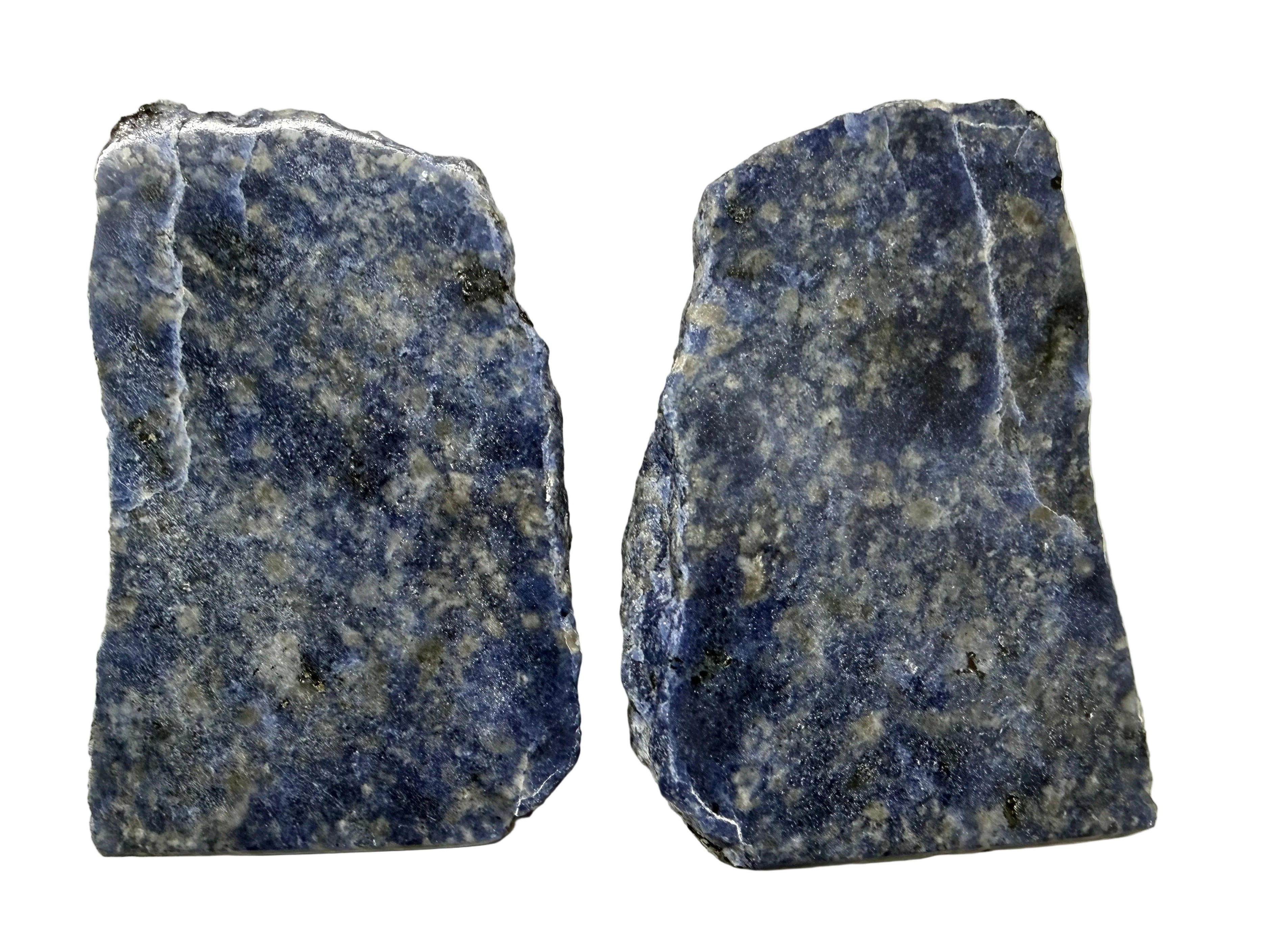 Two Sodalite Crystal specimens with naturally fractured edges, showing deep blue and white speckled patterns, displayed side-by-side on a light beige background.