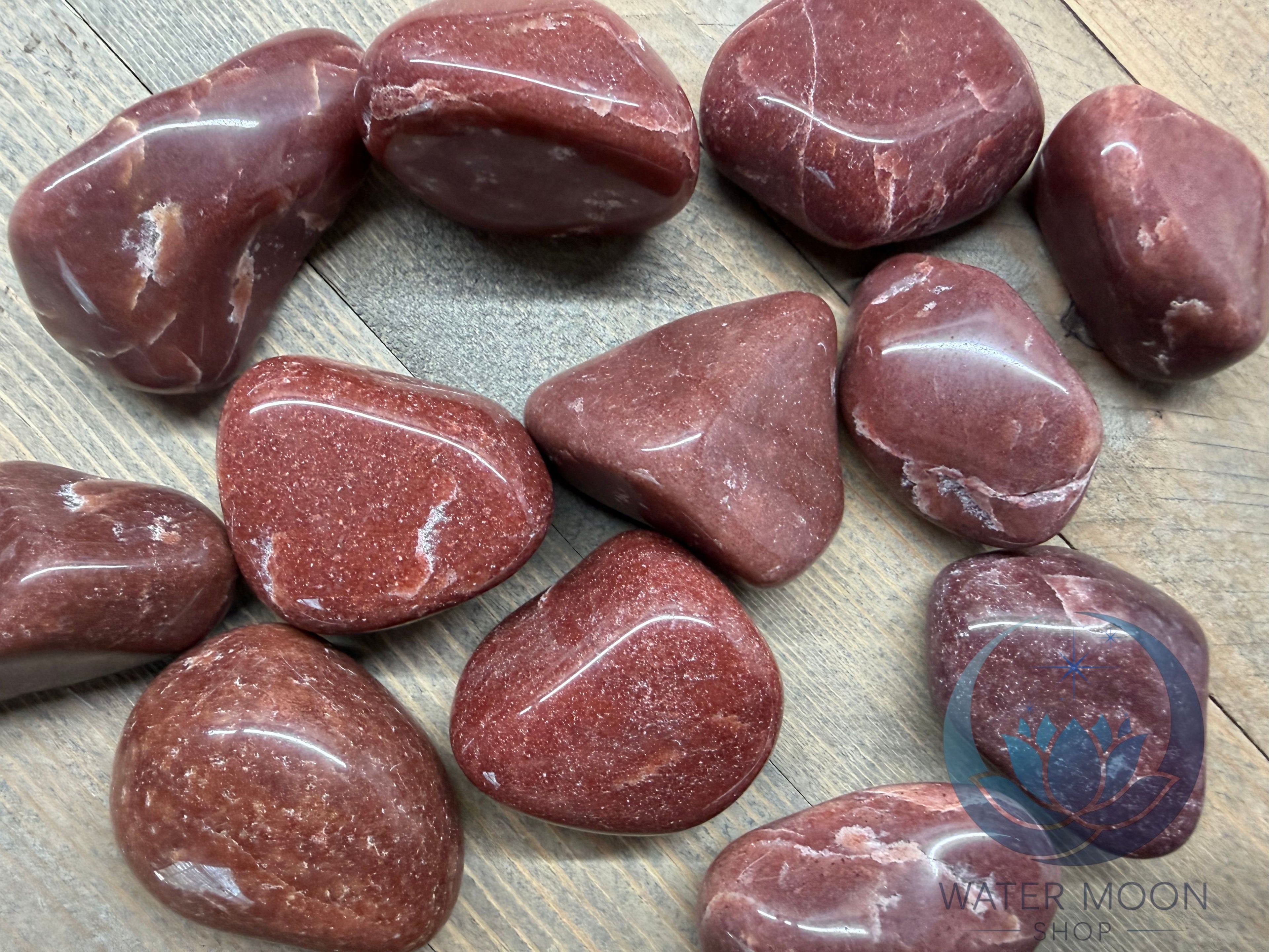Red marbled stones on a wooden surface