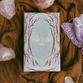 Star Seeker Tarot box on a textured brown fabric background with crystals and a butterfly.