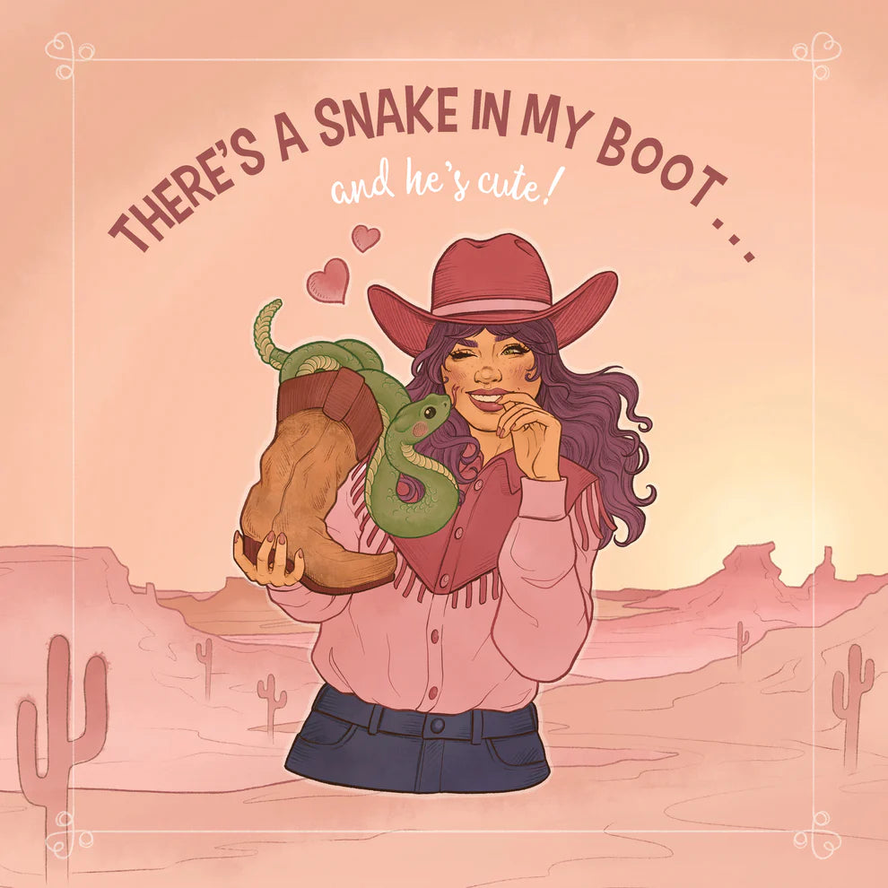 A stylized illustrated woman in a cowboy hat and pink top stands in a desert landscape holding a green snake coiled around a brown boot. The text above reads, 'THERE'S A SNAKE IN MY BOOT .